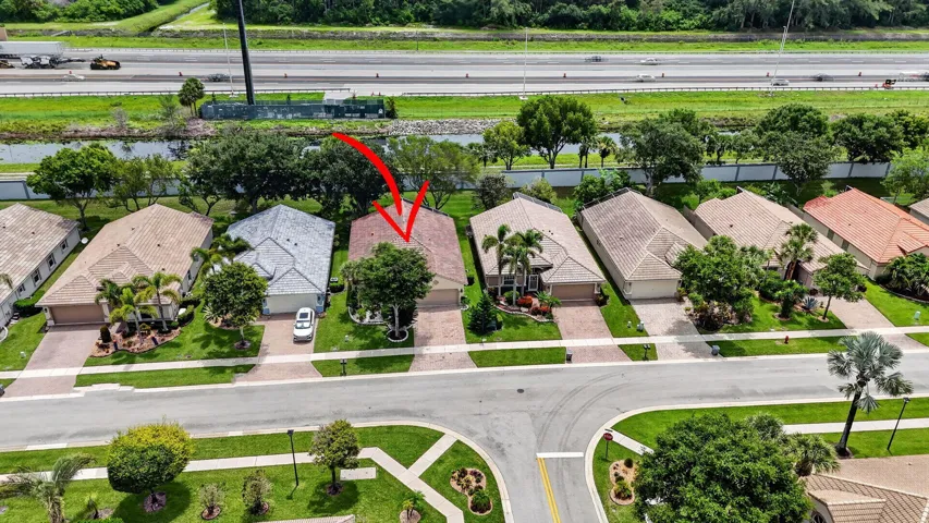 Aerial perspective of a residential property featuring a tiled roof and an attached garage