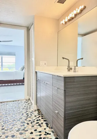 Primary en-suite bathroom jack and jill style for guest access