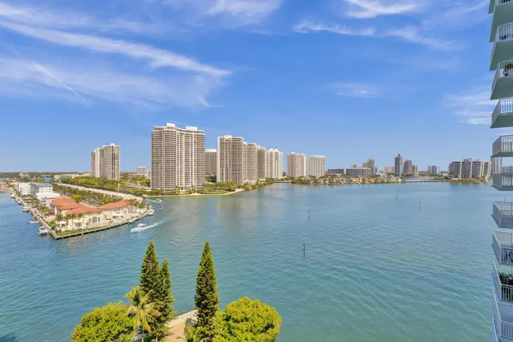 Expansive waterfront panorama featuring multiple high-rise buildings and a marina with docked boats