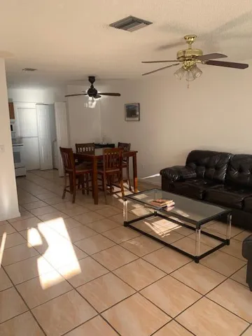 Open-concept living area with large format tile flooring
