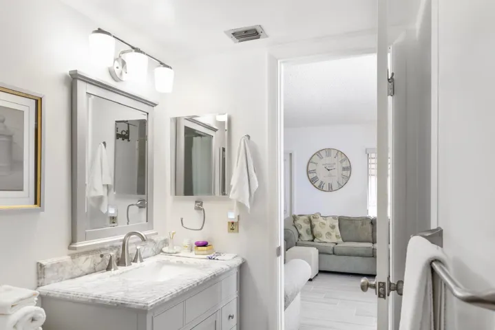 Looking at the living room from inside of the guest bath.