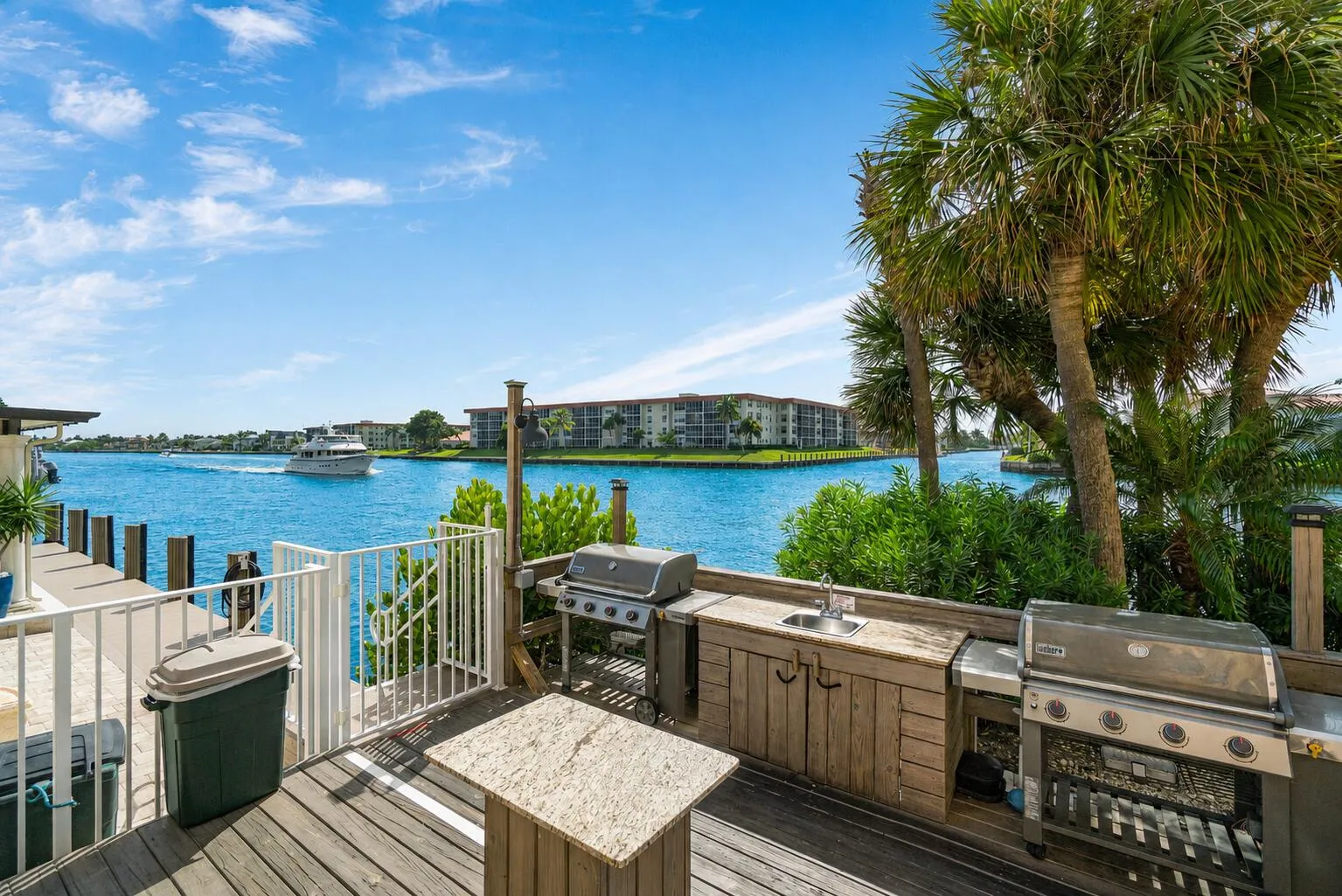 Beautiful waterfront grilling area with island and seating