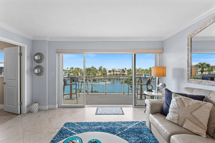 Spacious living area featuring large sliding glass doors opening to a balcony with waterway access