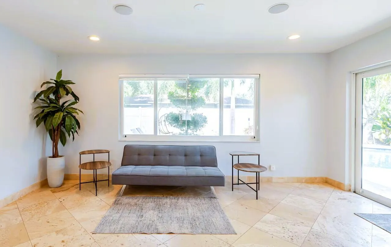 Spacious interior featuring large format tile flooring, recessed lighting, and a large window providing ample natural light