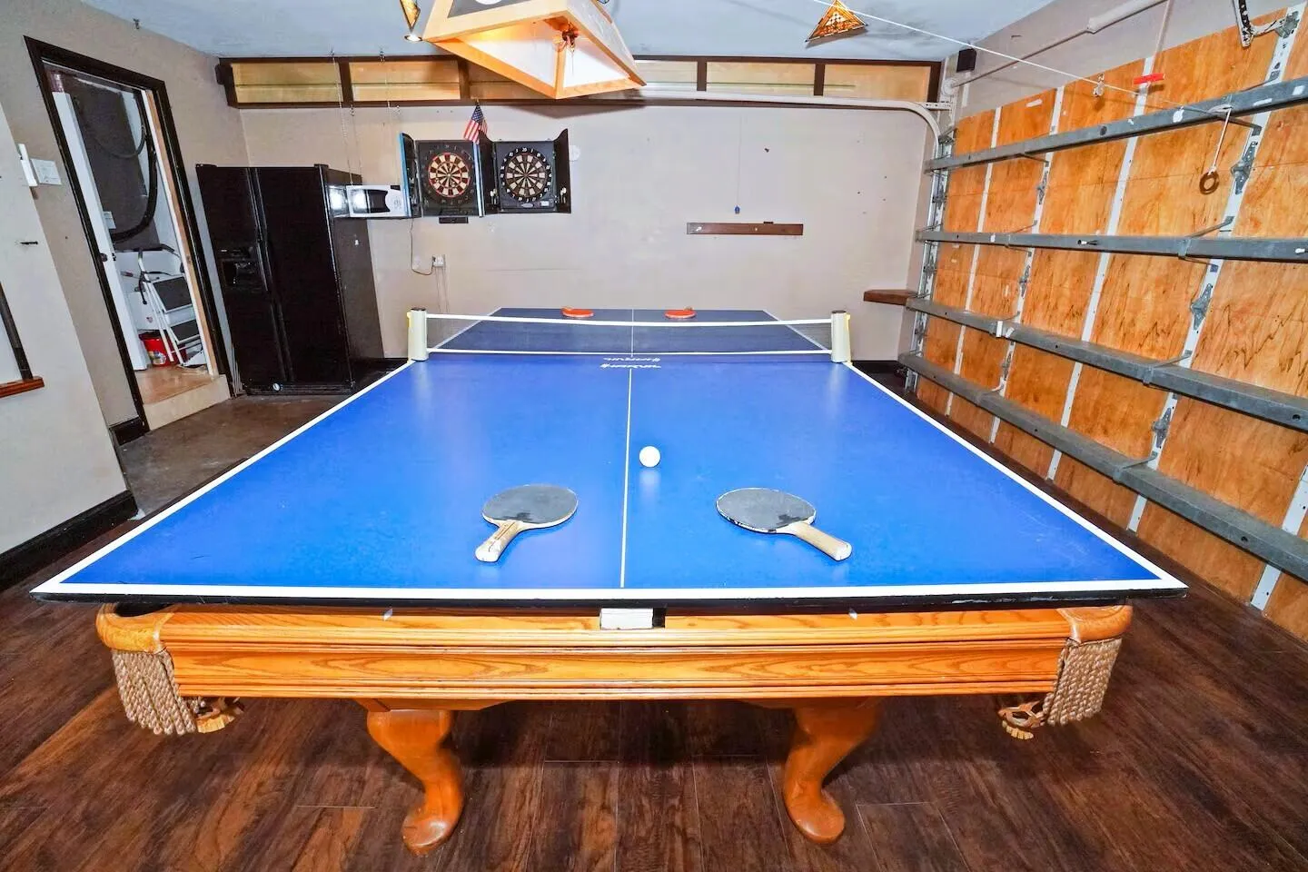 Recreation area featuring wood-finish flooring, a pool table base, and shelving