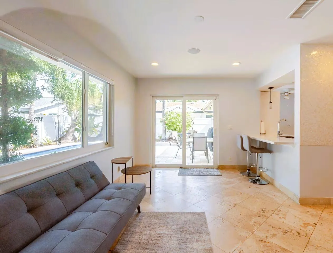 Open-concept living space featuring expansive windows, recessed lighting, and large format floor​​‌​​​​‌​​‌‌​‌‌​​​‌‌​‌​‌​‌​​​‌​​ tile