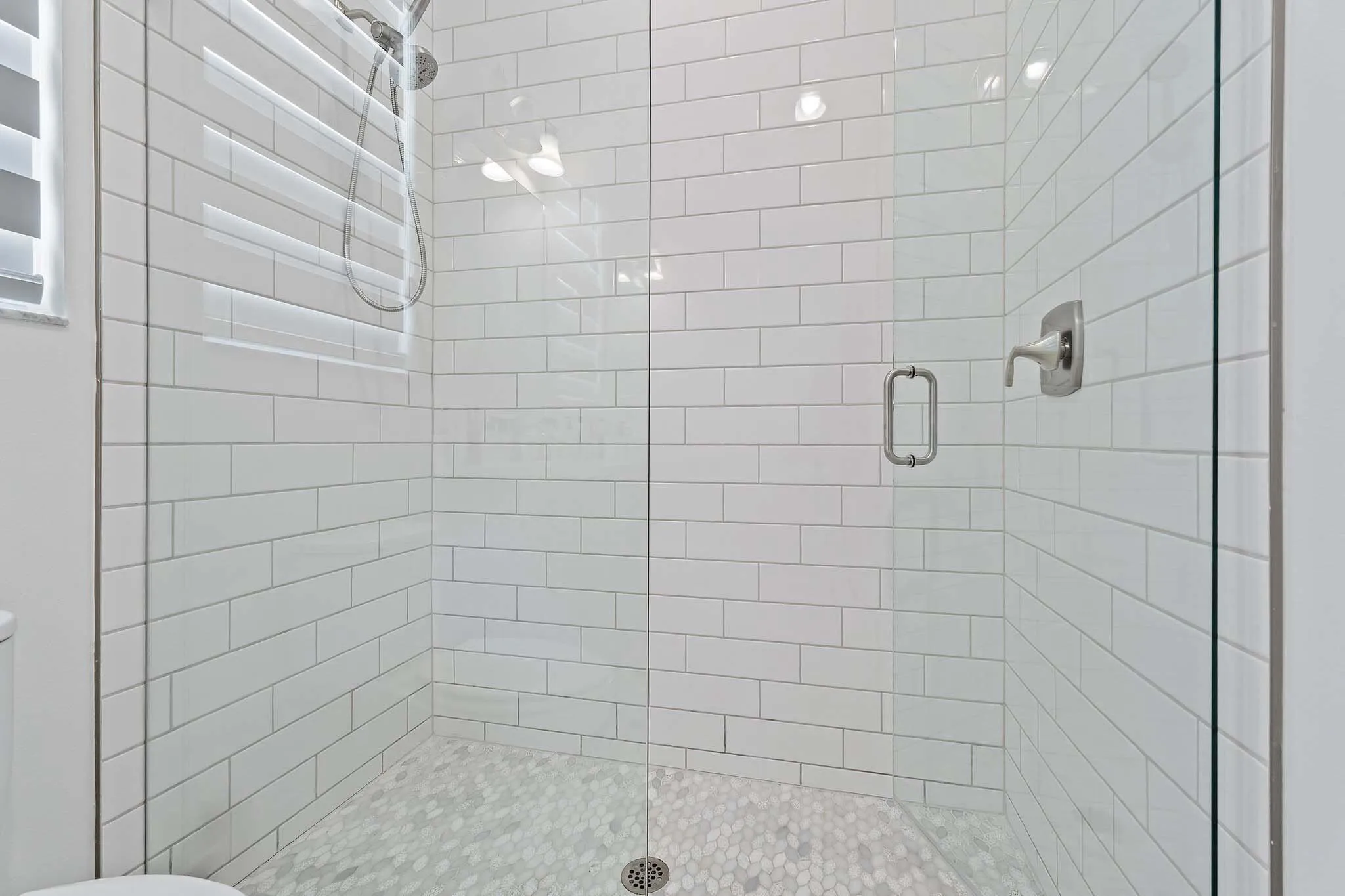 Subway tile shower with glass door