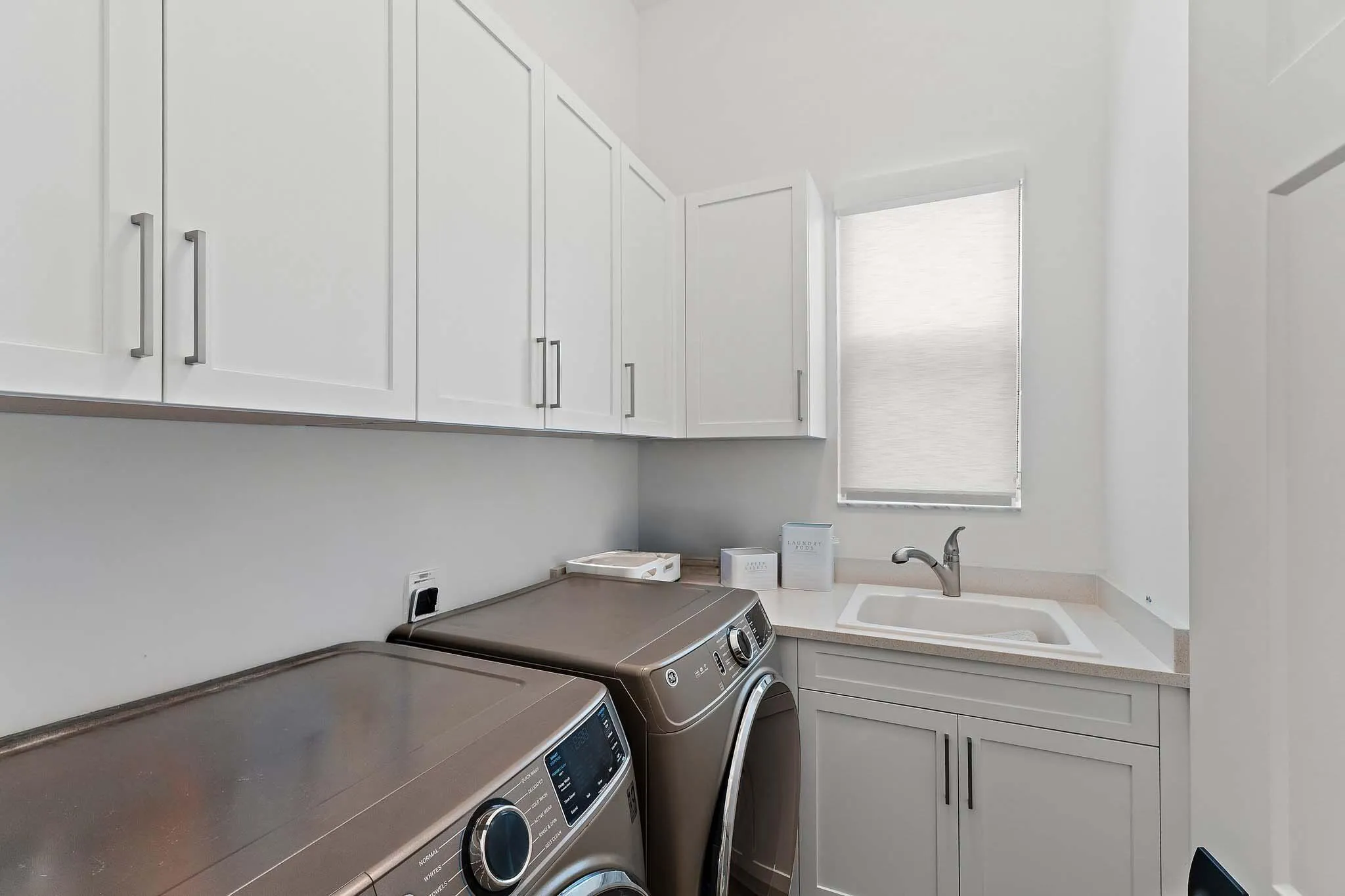 Laundry room with washer, dryer, and farmhouse sink