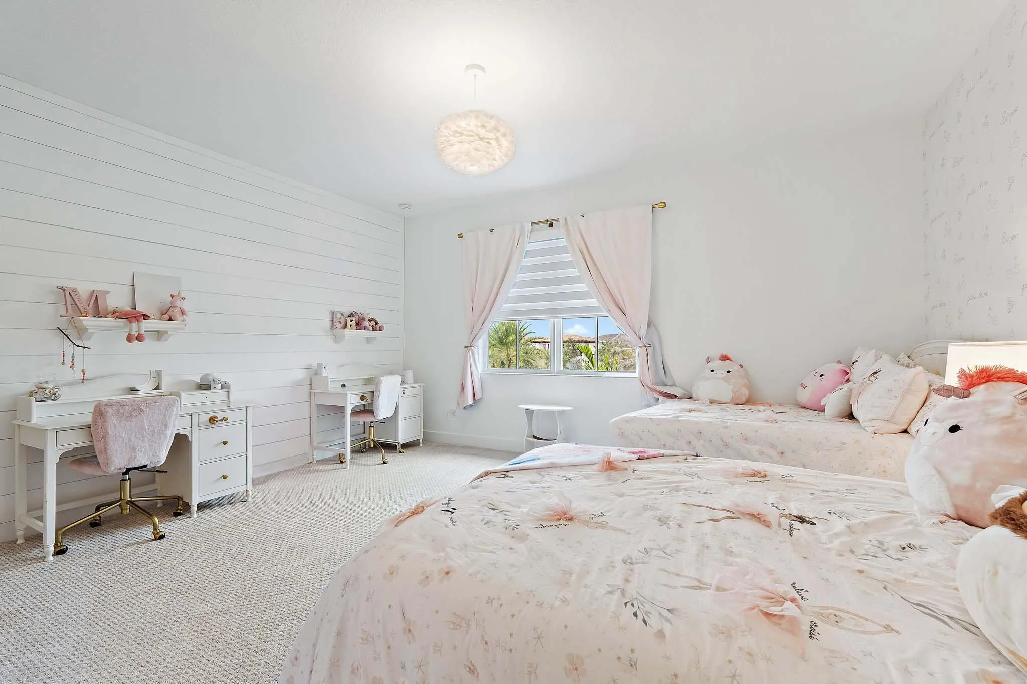Bedroom with white furniture, floral bedding, and desk area