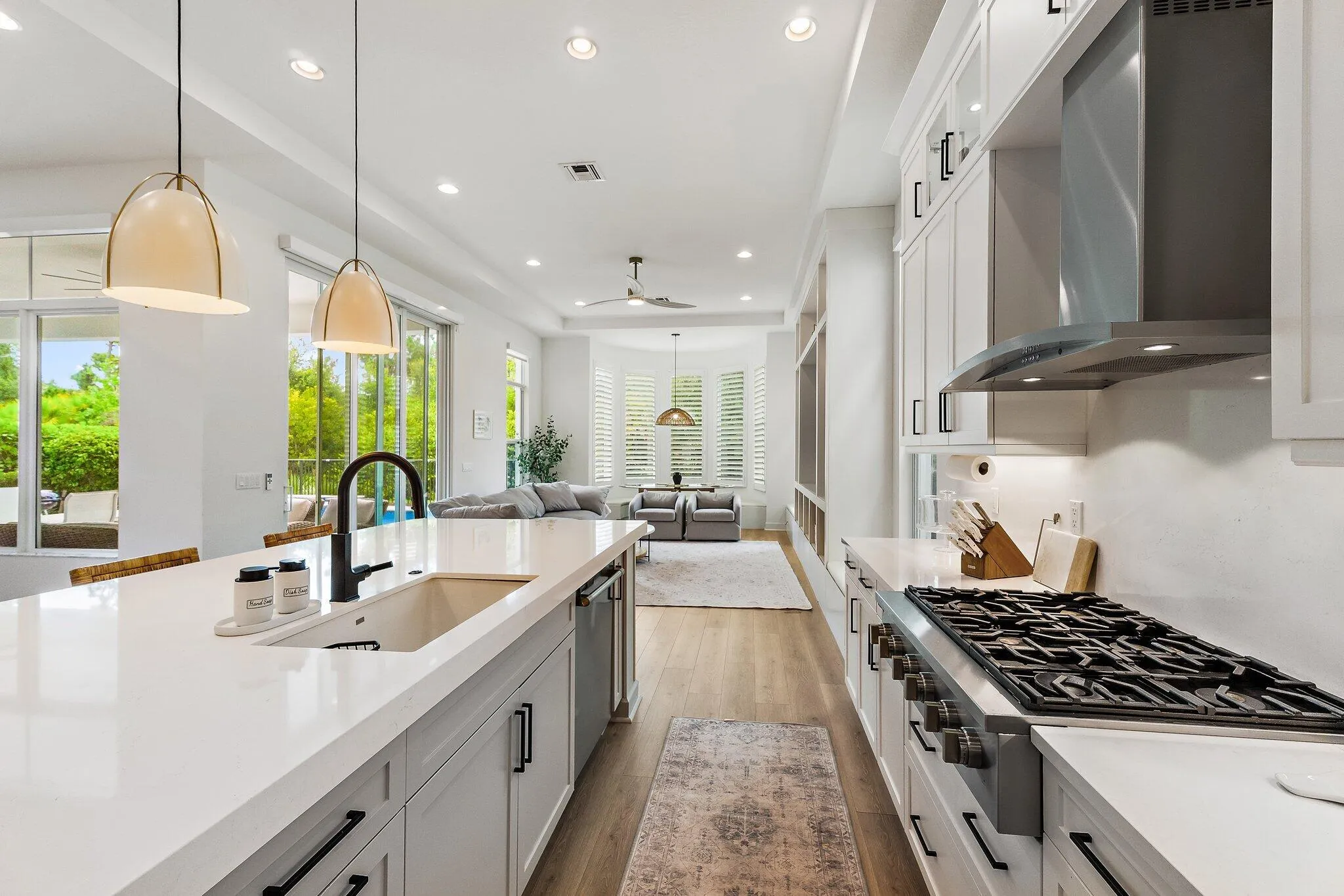 Kitchen with large island, professional range with hood, and view to outdoors