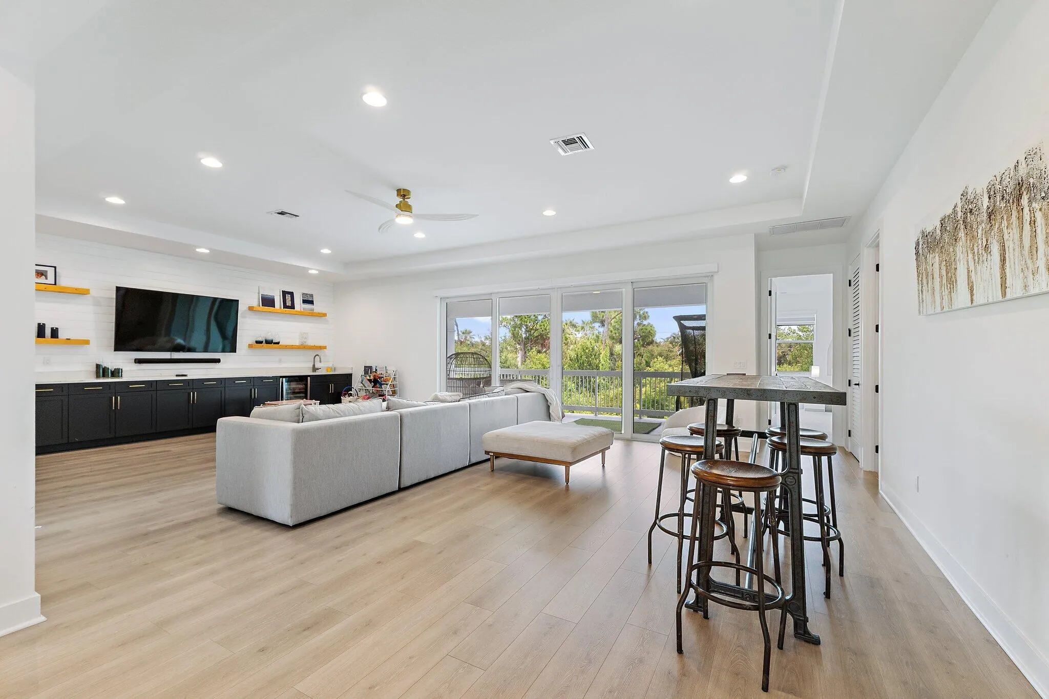Bonus room with kitchenette, seating area, and high-top bar table with stools