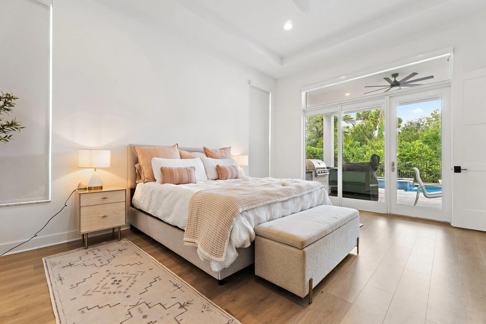 Primary bedroom with king bed, ceiling fan, and sliding glass doors to outside
