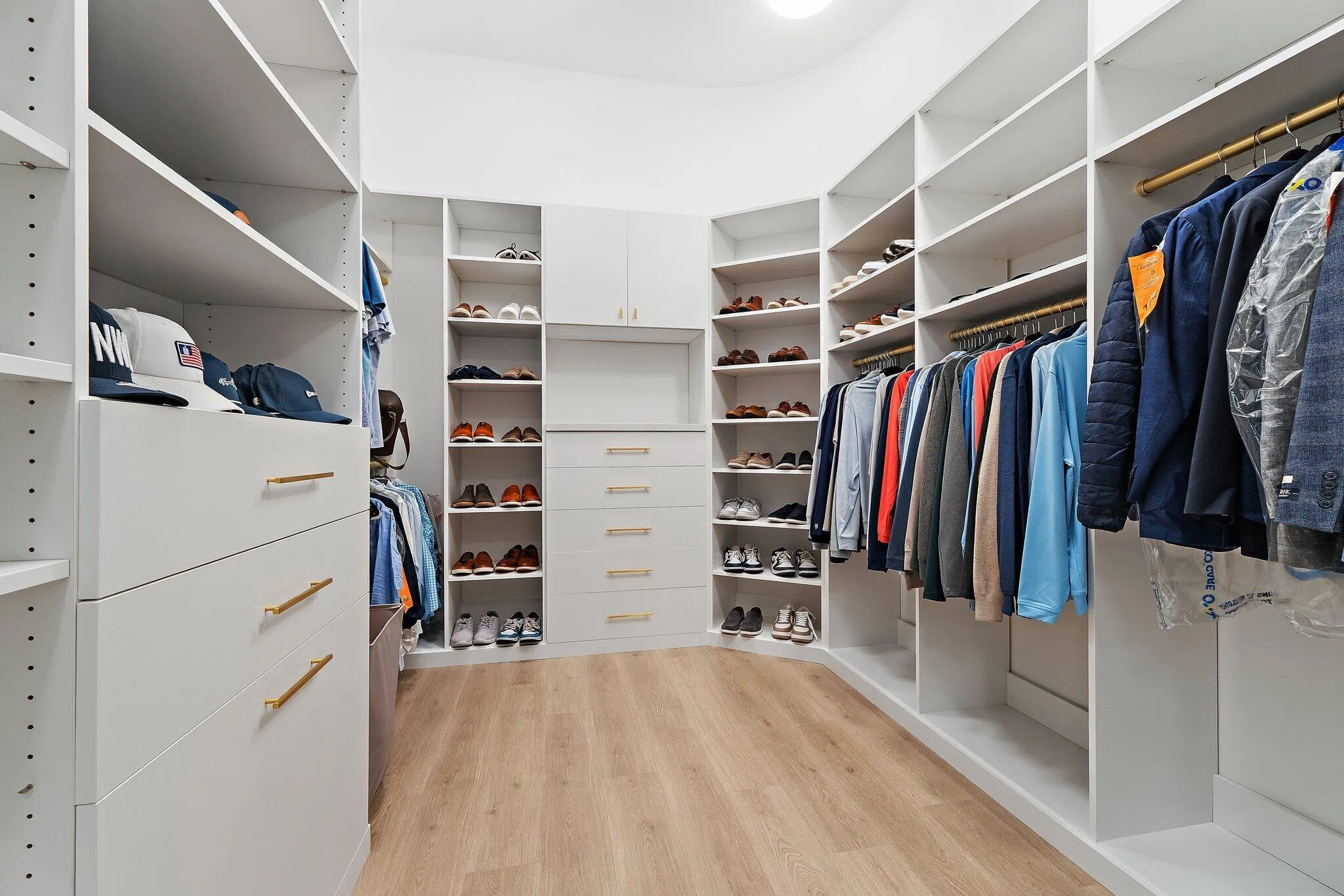Walk-in closet with custom built-in shelving and hanging storage