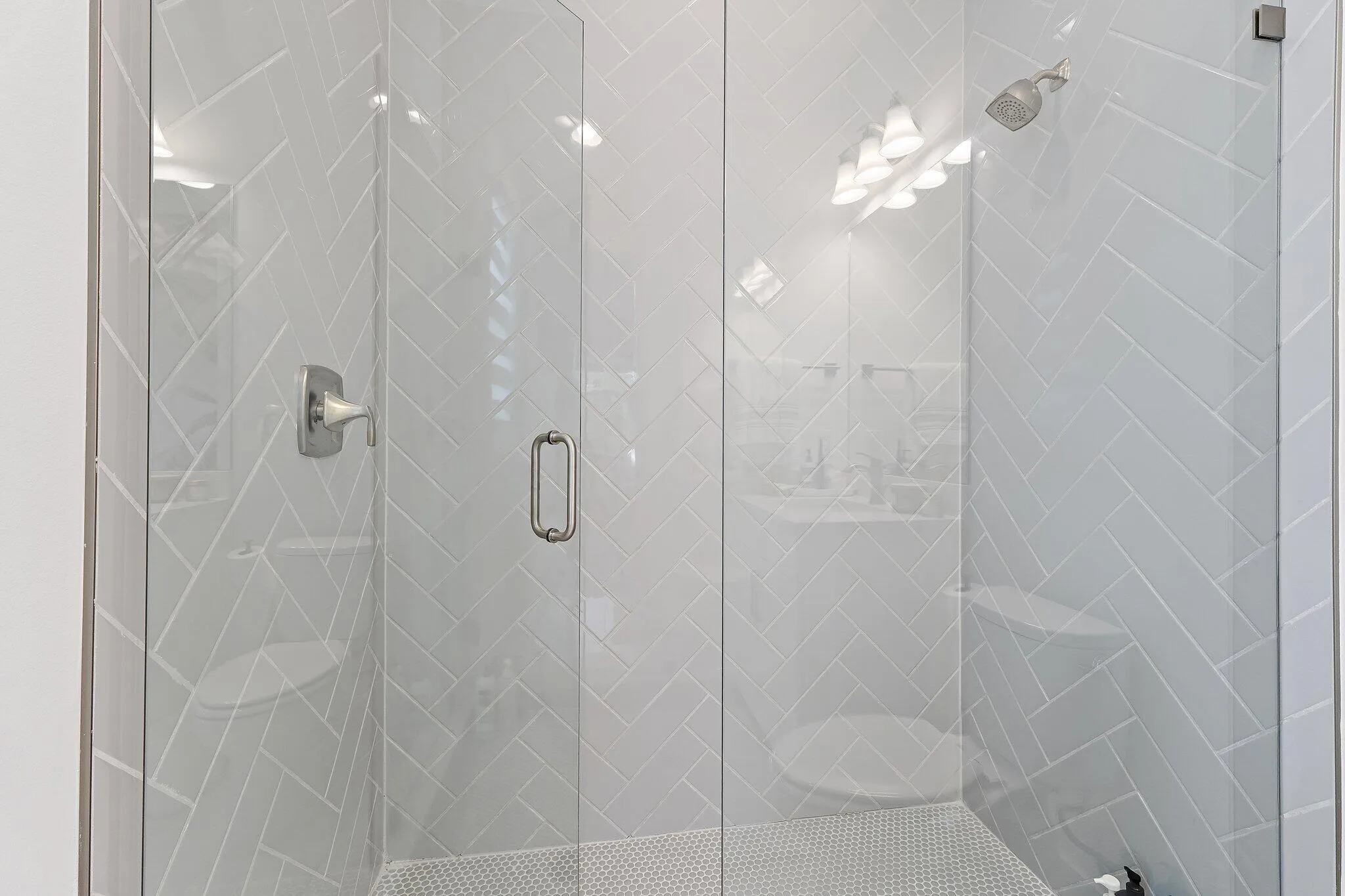 Glass-enclosed shower with tile surround