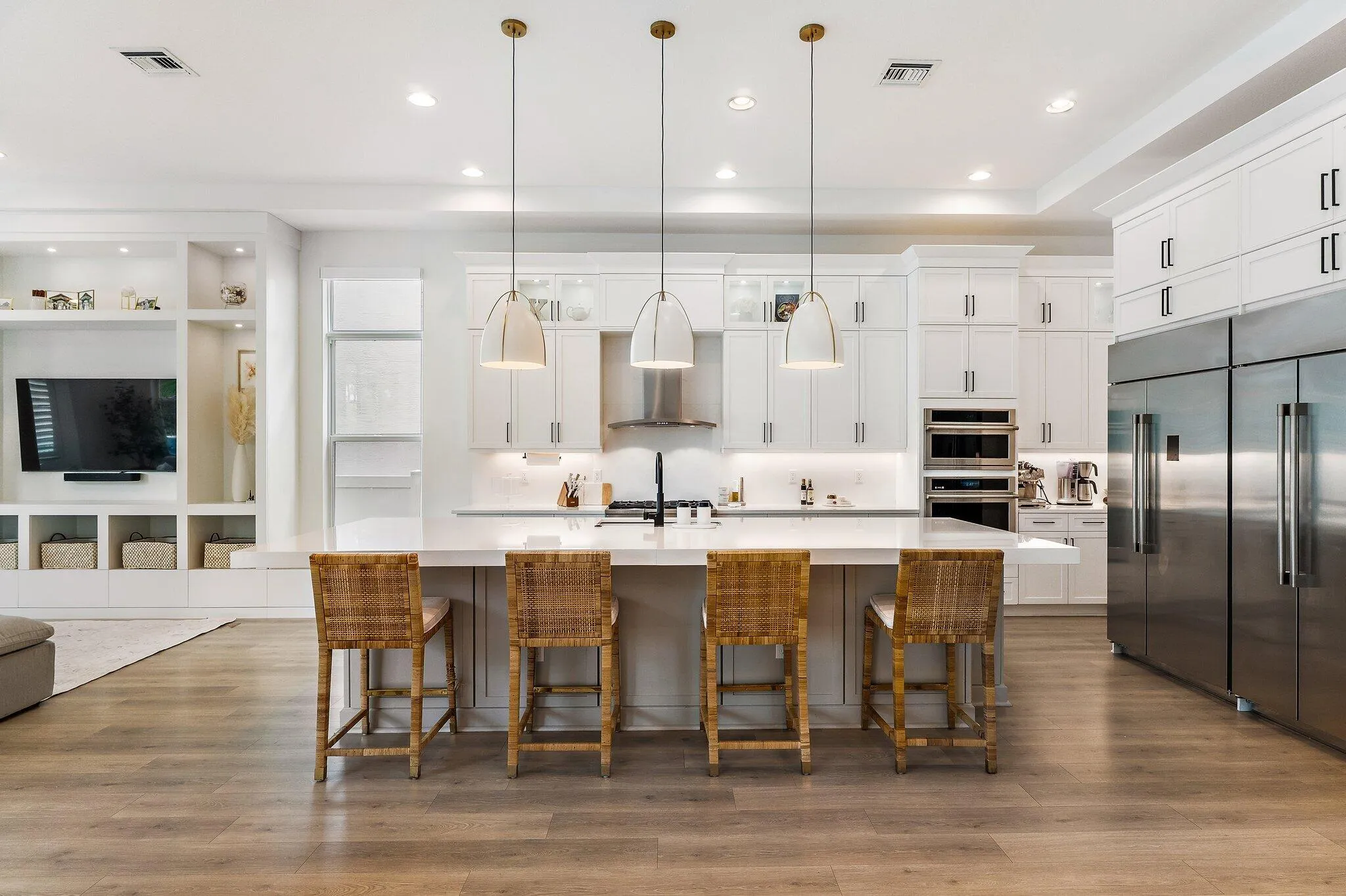 Kitchen with wood dining table, mounted TV, and dark cabinetry