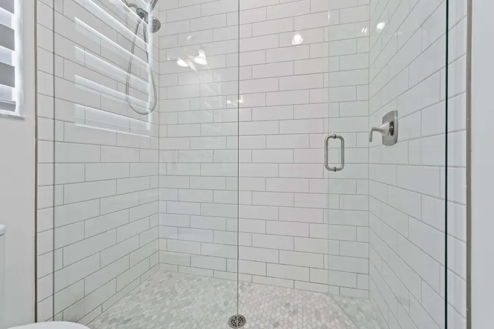 Subway tile shower with glass door