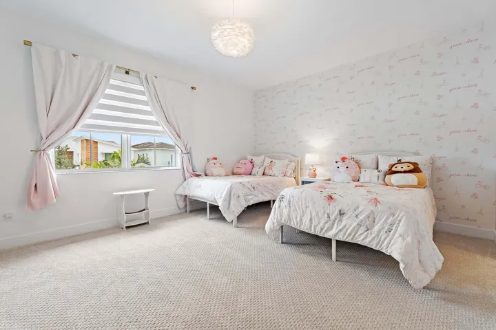 Bedroom with two twin beds and floral wallpaper