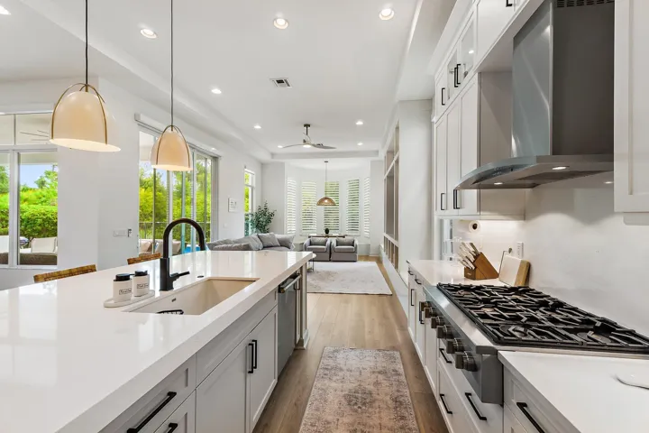 Kitchen with large island, professional range with hood, and view to outdoors