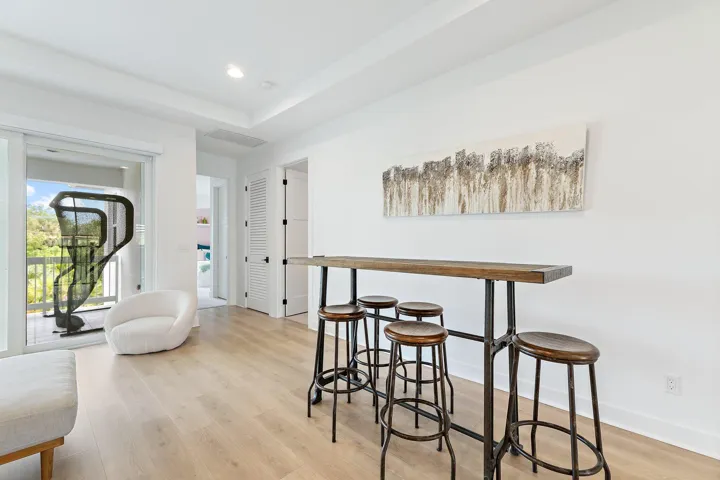 Bonus room with high-top bar table, stools, and exercise equipment