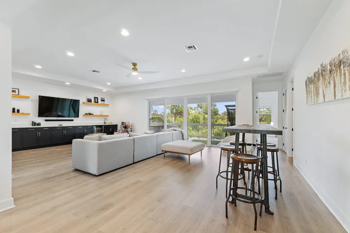 Bonus room with kitchenette, seating area, and high-top bar table with stools