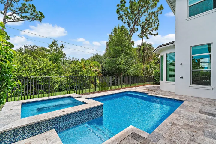 Backyard pool and spa view with paver deck near the house