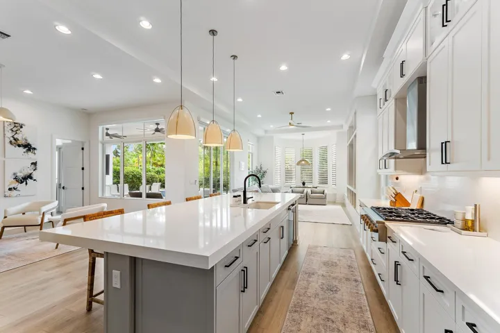 Kitchen with large island, pendant lighting, and view to adjoining living area