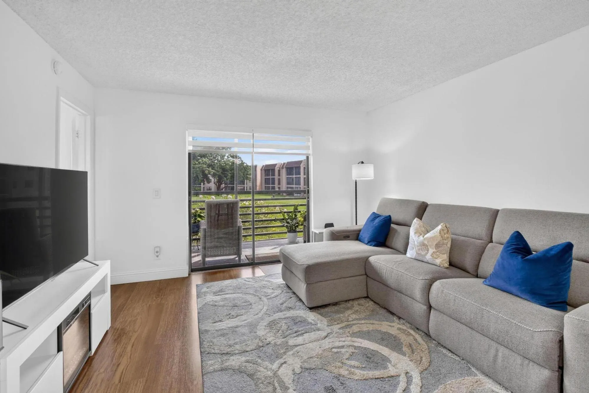 Spacious room open-concept layout, flooded with natural light through sliding glass doors