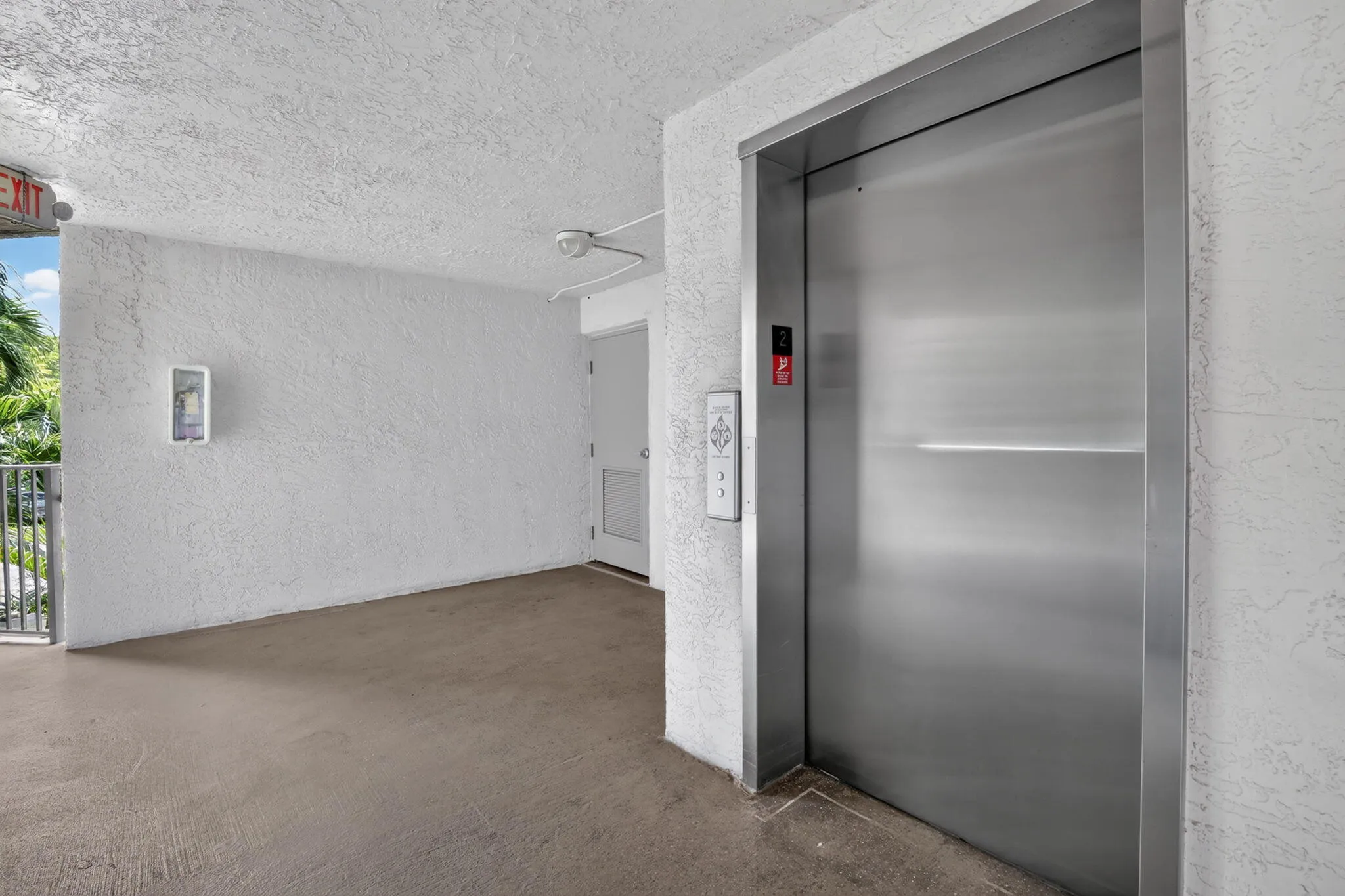 Stainless steel elevator doors with integrated call buttons