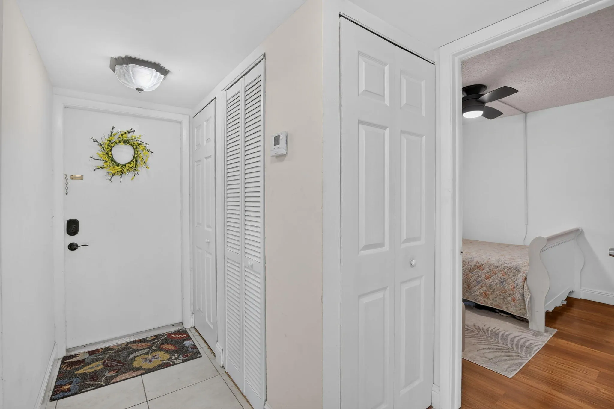 Entryway featuring light-toned tile flooring and a flush-mount ceiling light