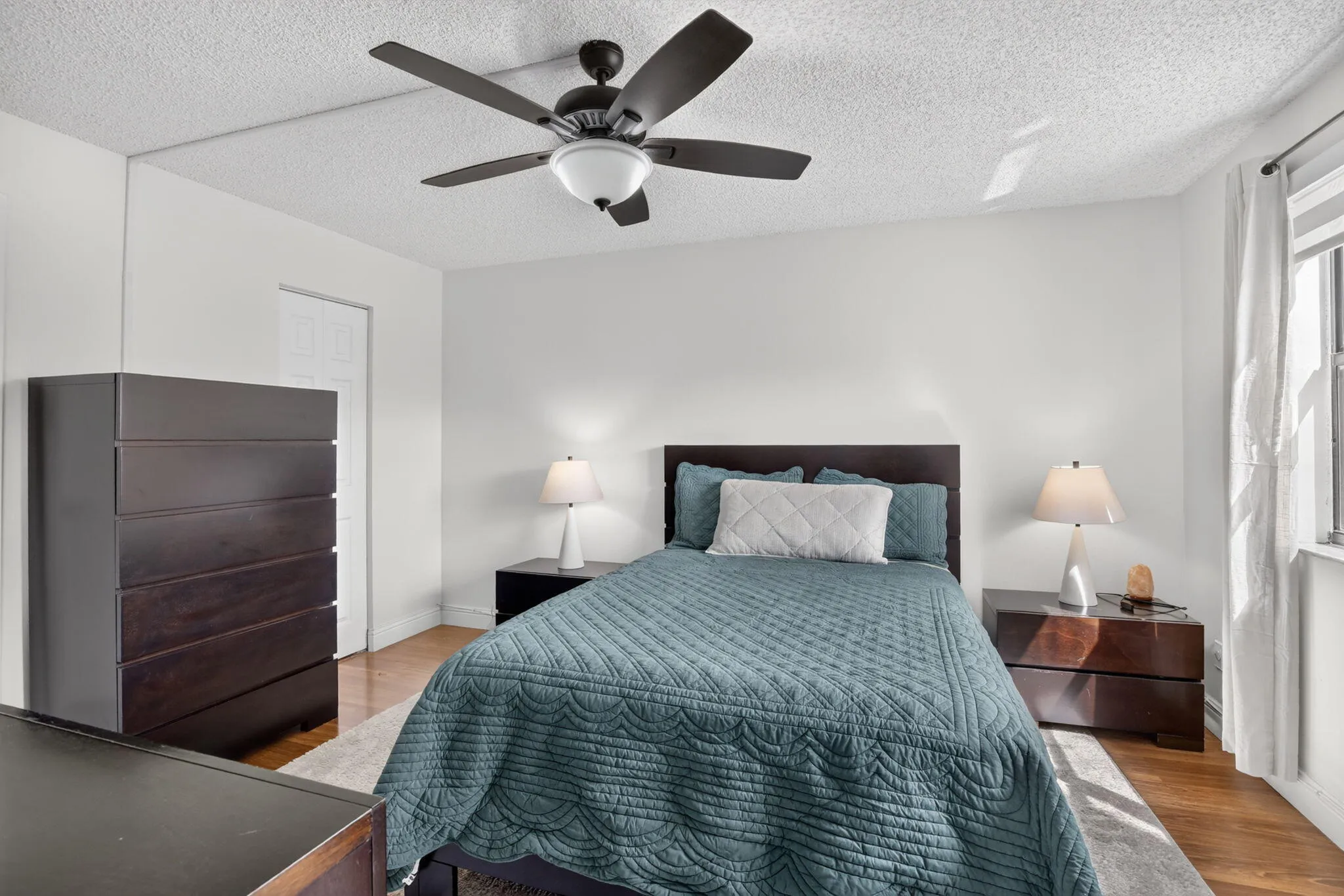 Primary Bedroom featuring laminate flooring and a ceiling fan with integrated lighting