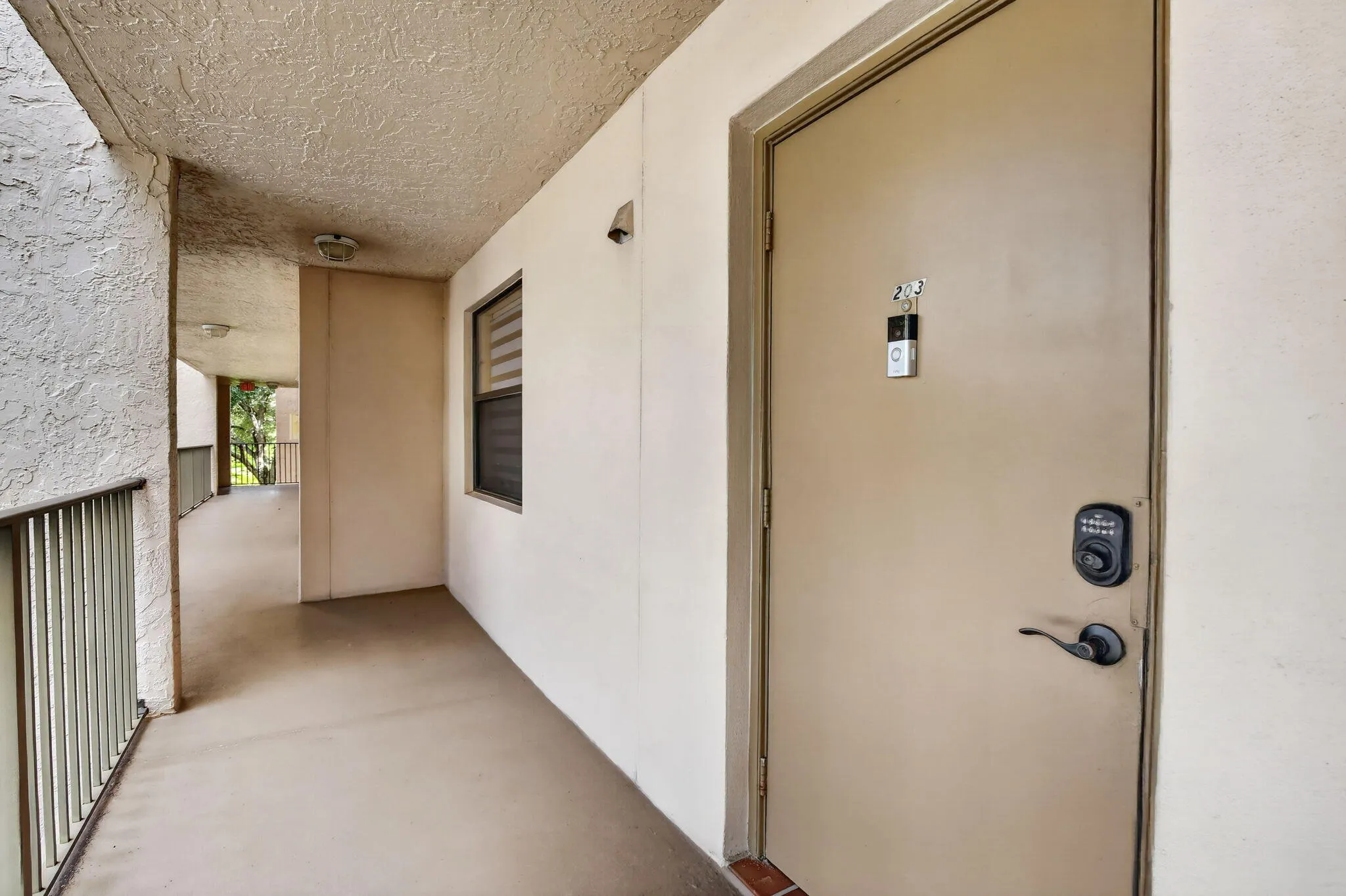 Entry door with dark bronze hardware and a keyless entry pad
