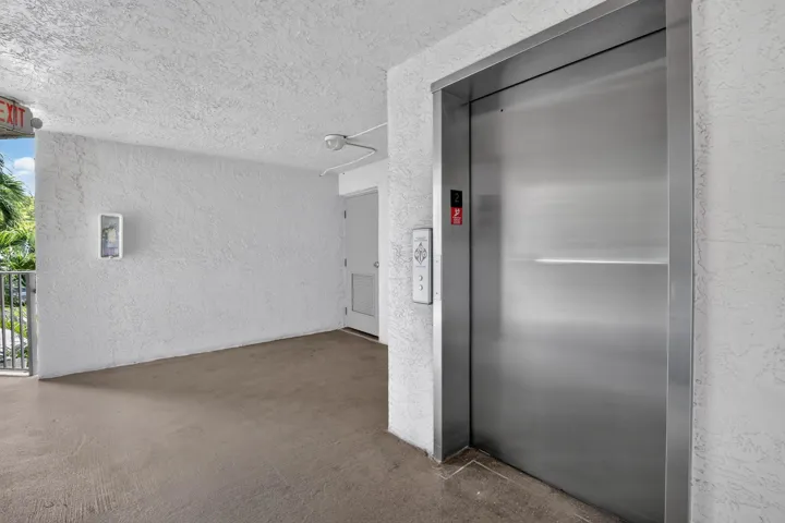 Stainless steel elevator doors with integrated call buttons