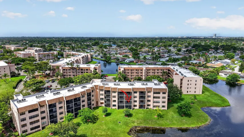 Aerial perspective highlighting multiple residential buildings with surrounding lake and water features