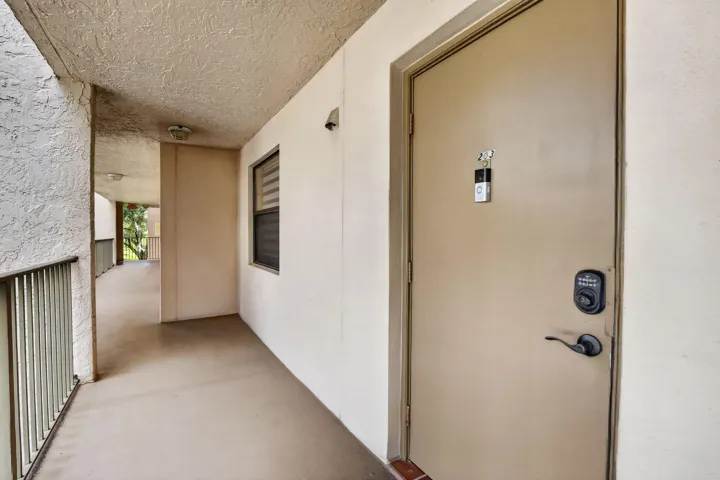Entry door with dark bronze hardware and a keyless entry pad