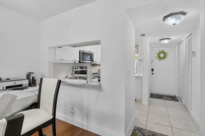 Kitchen pass-through window with a stainless steel sink and appliances