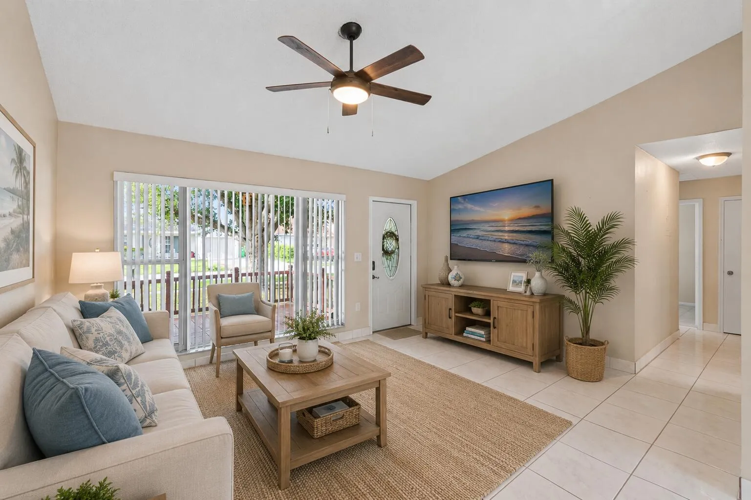 Spacious living room with volume ceiling and large picture window at the front of the house.