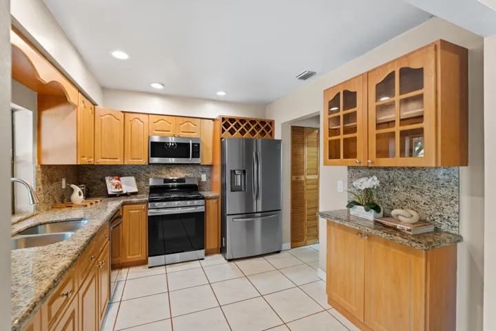 The kitchen features granite countertops, natural gas cooking, and 4 years new Samsung stainless steel appliances.