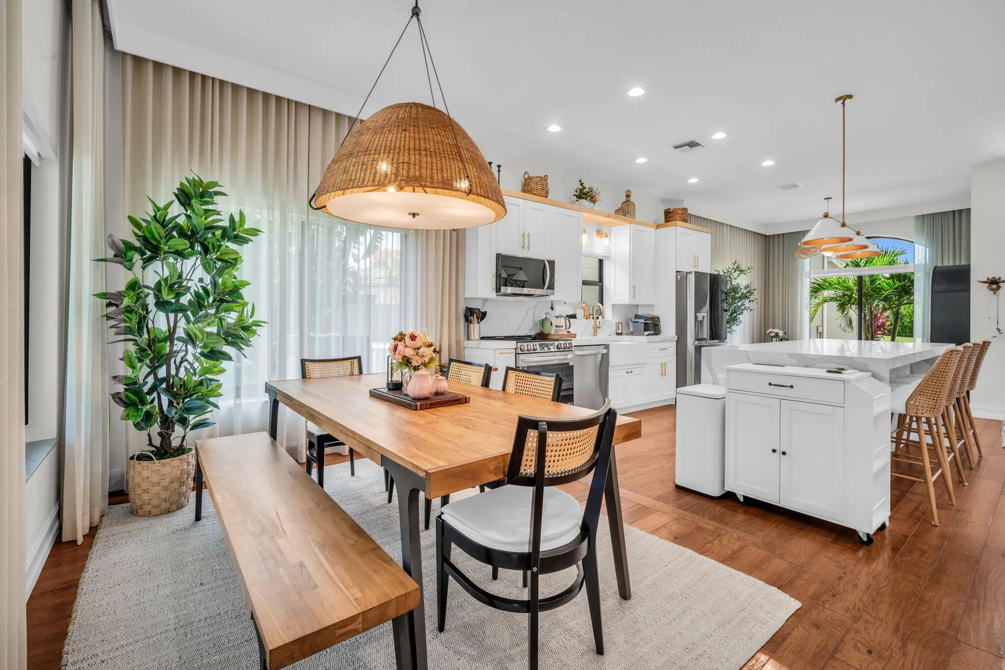 Spacious open-concept kitchen and dining area featuring rich wood-finish flooring