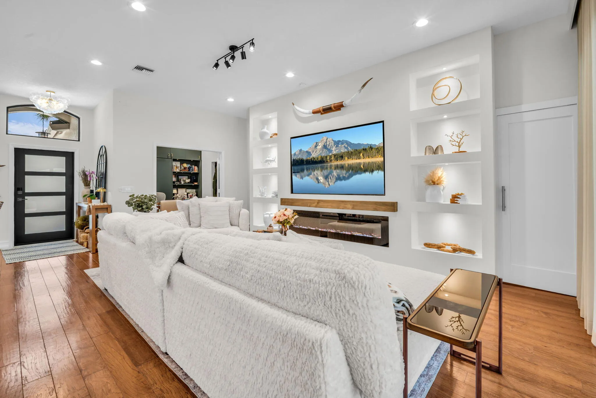 Living area featuring wood-finish flooring and recessed lighting