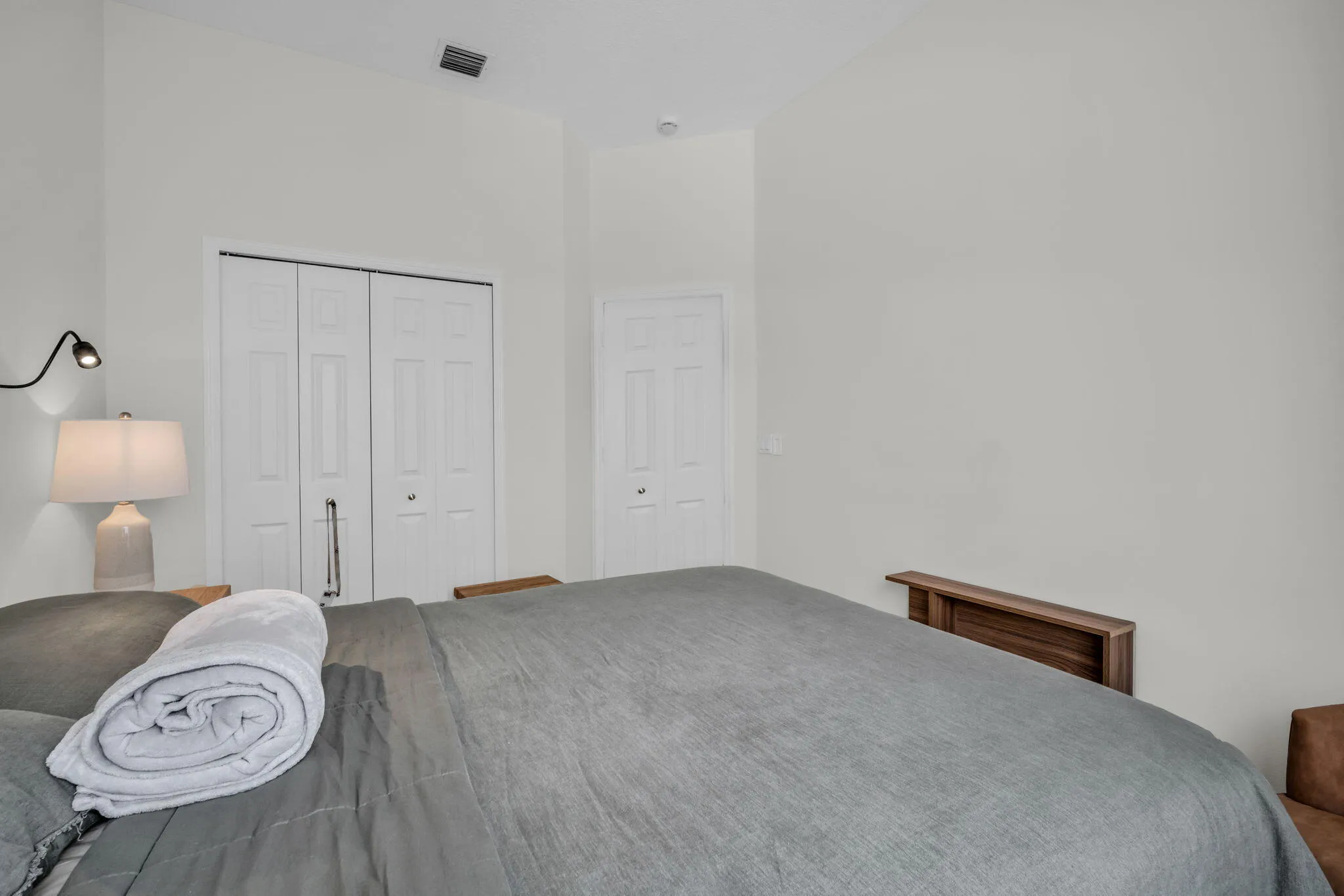 Vaulted ceiling with bright white walls, featuring a bifold closet and a secondary​​‌​​​​‌​​‌‌​‌‌​​​‌‌​‌​‌​‌​​​‌​​ door