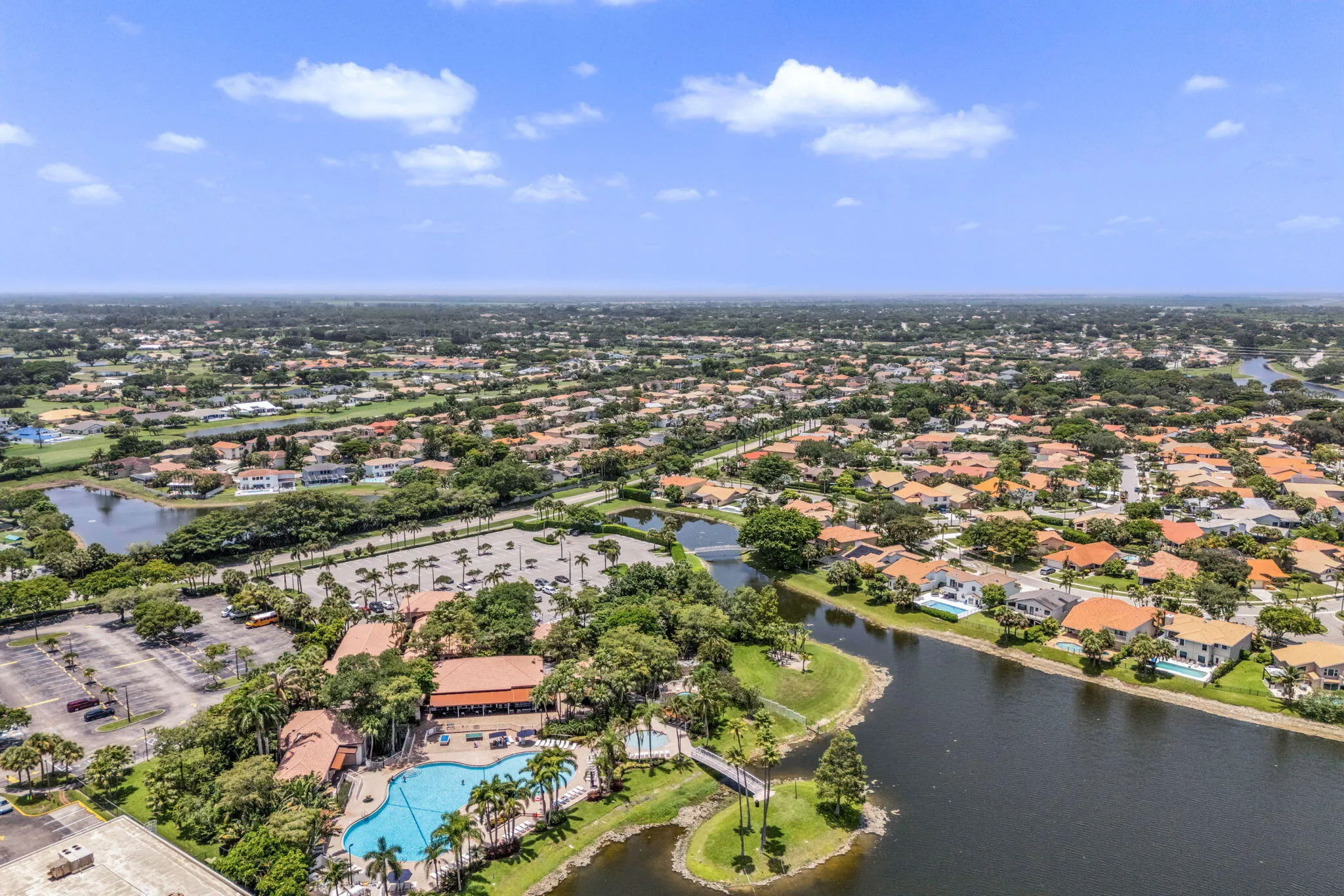 Aerial perspective showcasing a residential community with numerous homes featuring tile roofs