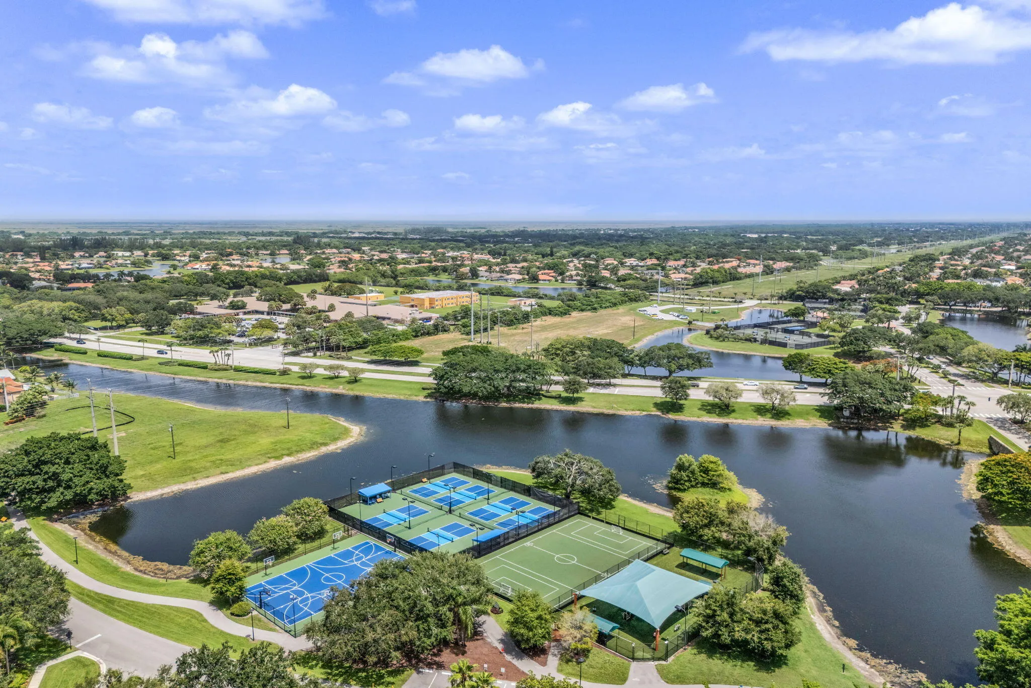 Recreational courts featuring multiple pickleball courts, a basketball court, and a multi-sport turf court