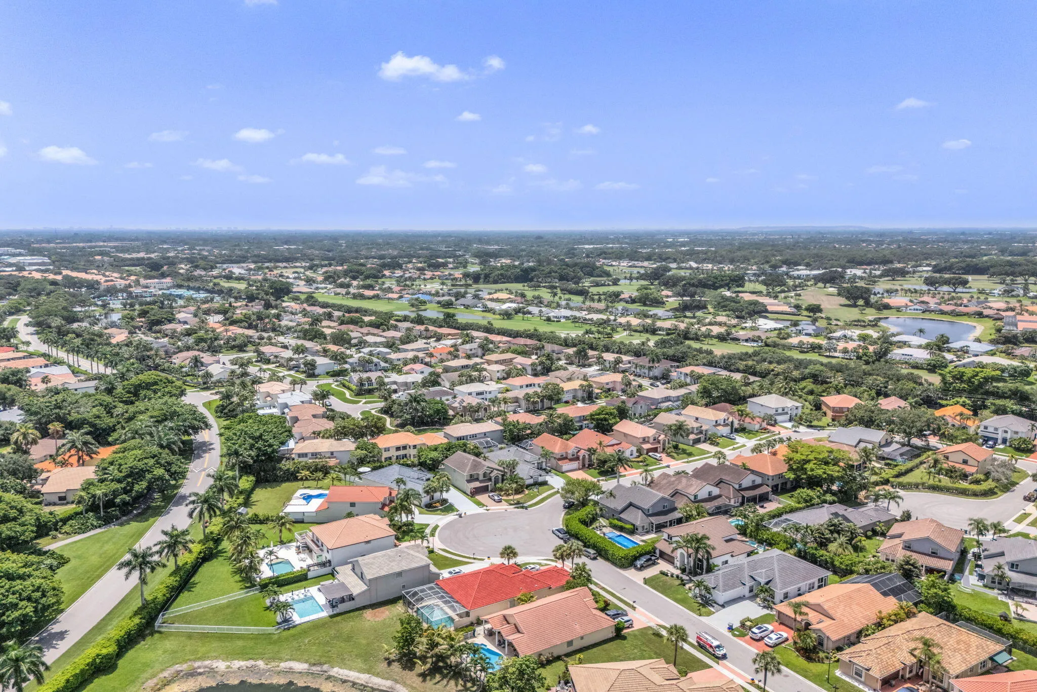 Aerial perspective showcasing a residential community with numerous homes featuring various architectural styles