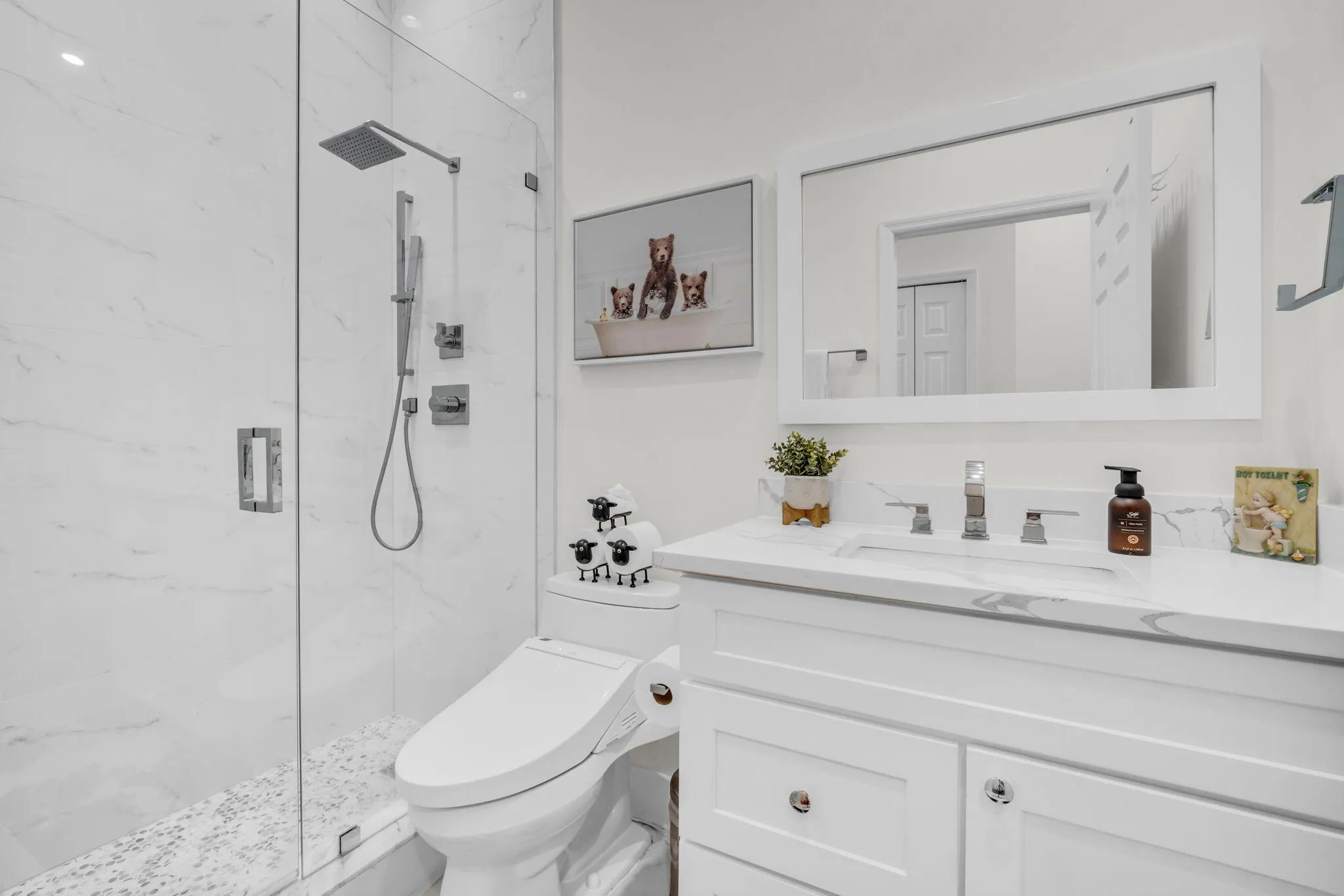 White vanity with a rectangular undermount sink and polished chrome faucet