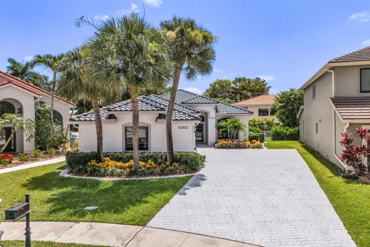 Contemporary stucco exterior with a dark tile roof