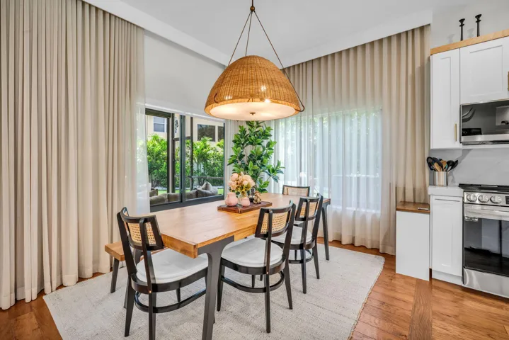 Dining area featuring wood-finish flooring and a central woven light fixture