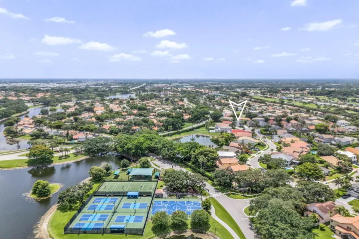 Aerial perspective showcasing a residential community with water features and mature landscaping