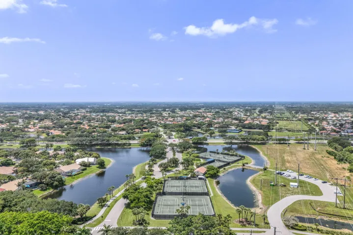 Aerial landscape showcasing multiple bodies of water, extensive green spaces, and a network of residential properties