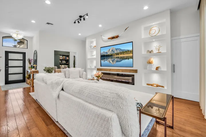 Living area featuring wood-finish flooring and recessed lighting