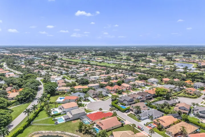 Aerial perspective showcasing a residential community with numerous homes featuring various architectural styles